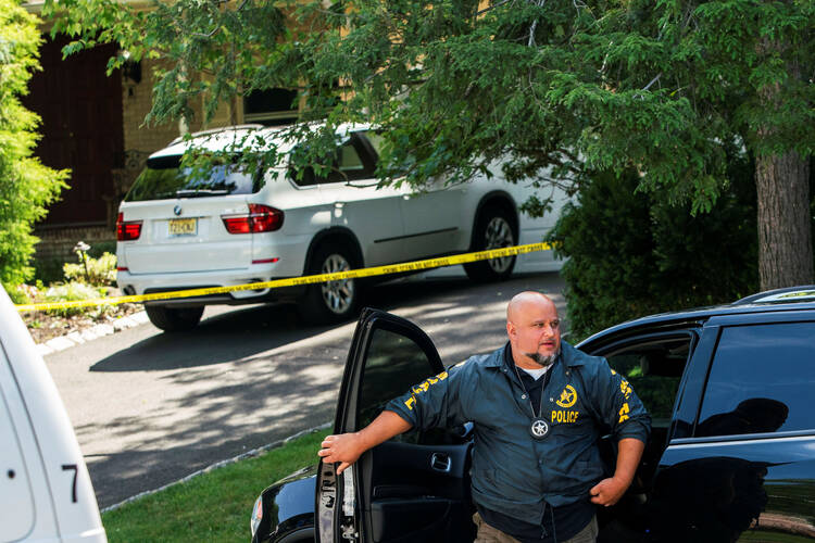 A law enforcement officer is seen outside of the North Brunswick, New Jersey, home of federal Judge Esther Salas, where her son was shot and killed and her defense attorney husband was critically injured July 19, 2020. Salas spoke publicly about the tragedy for the first time Aug. 3. (CNS photo/Eduardo Munoz, Reuters)
