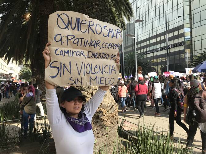 Joanely Martinez displays a sign—"I want to go out...to run, to walk, to enjoy myself without violence, without fear"—during the women's march on March 8, 2020, in Mexico City. She said the government "does nothing" to protect women, who are demanding the authorities do more to stop the murder of women and girls. (CNS photo/David Agren)