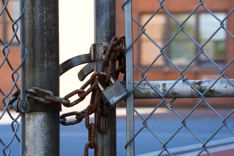 A locked fence is seen at a Catholic school. The Archdiocese of Newark, N.J., announced Aug. 4, 2020, it was permanently closing eight schools due to the economic hit caused by the coronavirus pandemic. (CNS photo/Gregory A. Shemitz)