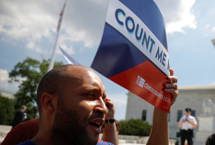 A protester holds a sign outside the U.S. Supreme Court on June 27, 2019, after the court ruled against adding a citizenship question to the 2020 census. (CNS photo/Carlos Barria, Reuters) 