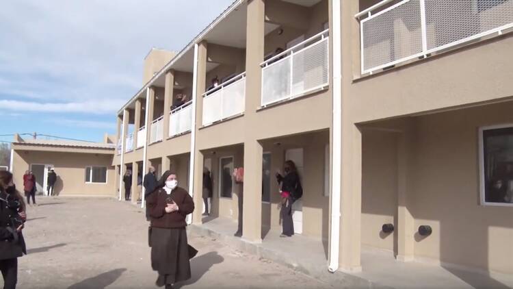 People tour a new housing complex for trans women after a ribbon cutting in Neuquén, Argentina, in August 2020. (AP/video screengrab)