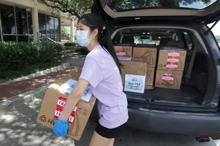 Valerie Xu, 15, delivers a donation, boxes of mask to UT Southwestern Medical Center in Dallas, Friday, June 5, 2020. Xu is among teens across the U.S. who decided to take action as the coronavirus pandemic took hold, doing everything from delivering groceries to older people to offering online tutoring, to emailing sick children and to raising money to help feed the hungry. (AP Photo/Tony Gutierrez)