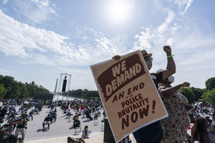 People gather at the Lincoln Memorial in Washington on Aug. 28, the 57th anniversary of the Rev. Martin Luther King Jr.'s "I Have A Dream" speech and the March on Washington. (AP Photo/Alex Brandon)