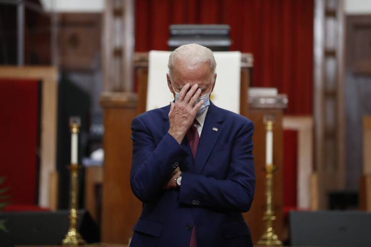 Democratic presidential candidate and former Vice President Joe Biden touches his face as he speaks to members of the clergy and community leaders at Bethel AME Church in Wilmington, Del., on June 1. Democrats are betting on Biden’s evident comfort with faith as a powerful point of contrast in his battle against President Donald Trump. (AP Photo/Andrew Harnik, File)