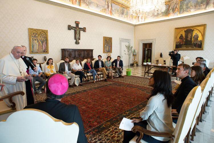Pope Francis meets with a group of clergy and laypeople advising the French bishops' conference on ecological policies and on promoting the teaching in his encyclical, "Laudato Si', On Care for Our Common Home" on Sept. 3, 2020. Actress Juliette Binoche, to the pope's left in the white and yellow blouse, was part of the meeting in the library of the Apostolic Palace at the Vatican. (CNS photo/Vatican Media)