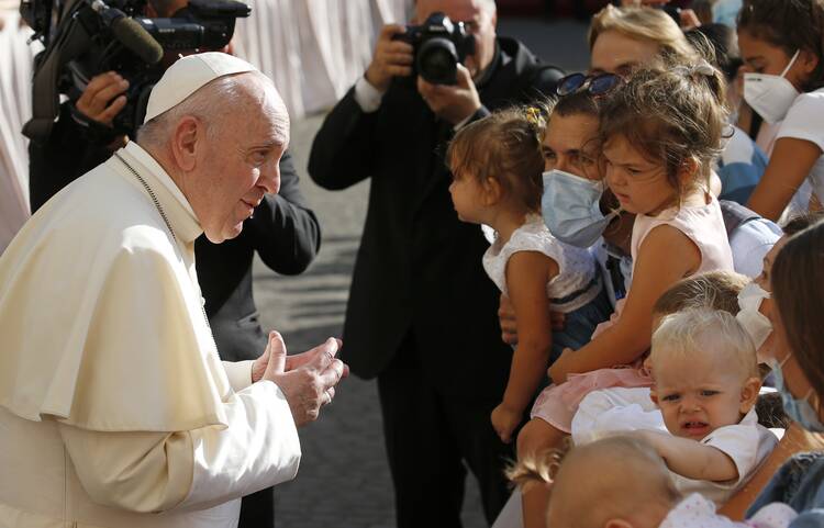 Pope Francis greets people as he arrives for his general audience in the San Damaso courtyard at the Vatican Sept. 9, 2020. (CNS photo/Paul Haring)