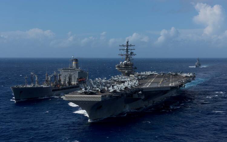 In this 2017 file photo, the U.S. Navy aircraft carrier USS Ronald Reagan is seen as a replenishment-at-sea is conducted with the Military Sealift Command's fleet replenishment oiler USNS John Ericsson in waters around Okinawa, Japan. (CNS photo/U.S. Navy, Mass Communication Specialist 2nd Class Kenneth Abbate via Reuters)