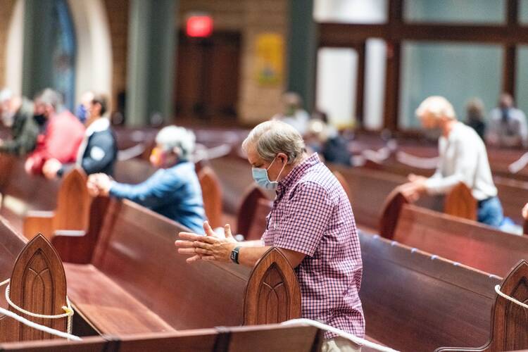 Mark Galli kneels during Mass at St. Michael Catholic Church, Tuesday, Sept. 8, 2020, in Wheaton, Illinois. RNS photo by Tom Killoran