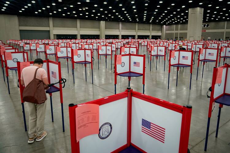 A voter in Louisville, Ky., completes his ballot for his state’s primary election, held on June 23. (CNS photo/Bryan Woolston, Reuters)