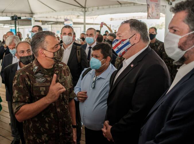 Gen. Manoel de Barros, commander of the Brazil's Humanitarian Logistics Task Force and operational coordinator of Operation Welcome, which aims at offering support to Venezuelan immigrants, speaks with U.S. Secretary of State Mike Pompeo in Boa Vista, Brazil, Sept.18, 2020. (CNS photo/Bruno Mancinelle, IOM/Pool via Reuters)