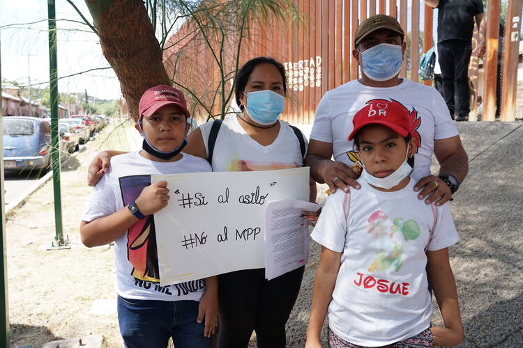 Xiomara Martinez, pictured here with her two children, both U.S. citizens, and her brother, Sergio, traveled to Nogales, Sonora. They have been waiting to petition for asylum for six months. (J.D. Long-García)