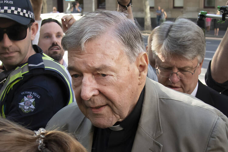 In this Feb. 27, 2019, file photo, Cardinal George Pell arrives at the County Court in Melbourne, Australia. Pell, Pope Francis' former finance minister, will soon return to the Vatican during an extraordinary economic scandal for the first time since he was cleared of child abuse allegations in Australia five months ago, a newspaper has reported, Monday, Sept. 28, 2020. (AP Photo/Andy Brownbill, File)
