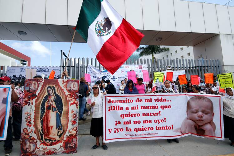 Pro-life supporters pray during a 2019 protest outside the local congress in Oaxaca, Mexico. In late July, Mexico's bishops called on Catholics to speak out ahead of a ruling from the country's Supreme Court, which could lead to a nationwide decriminalization of abortion. (CNS photo/Jorge Luis Plata, Reuters)