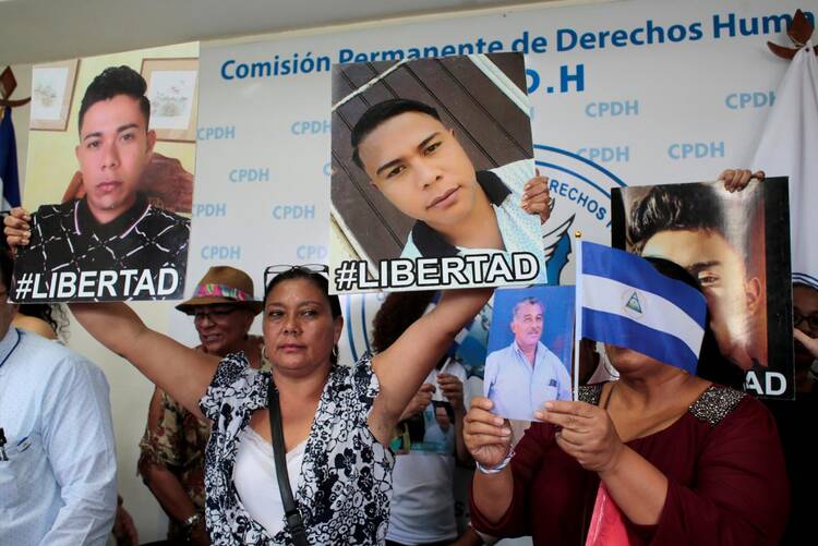 Relatives hold pictures during a 2019 news conference in Managua to demand the release of the demonstrators detained during 2018 protests against the government. (CNS photo/Oswaldo Rivas, Reuters)