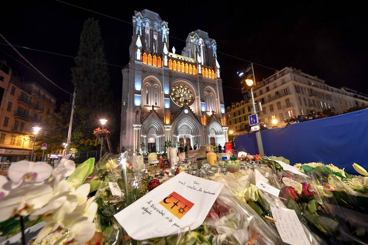 Tributes to the dead are seen outside of Notre Dame Basilica in Nice, France, Nov. 1, 2020, as French bishops conduct a "penitential rite of reparation," following the Oct. 29 deadly attack at church. (CNS photo/Lionel Urman, Panoramic via Reuters)