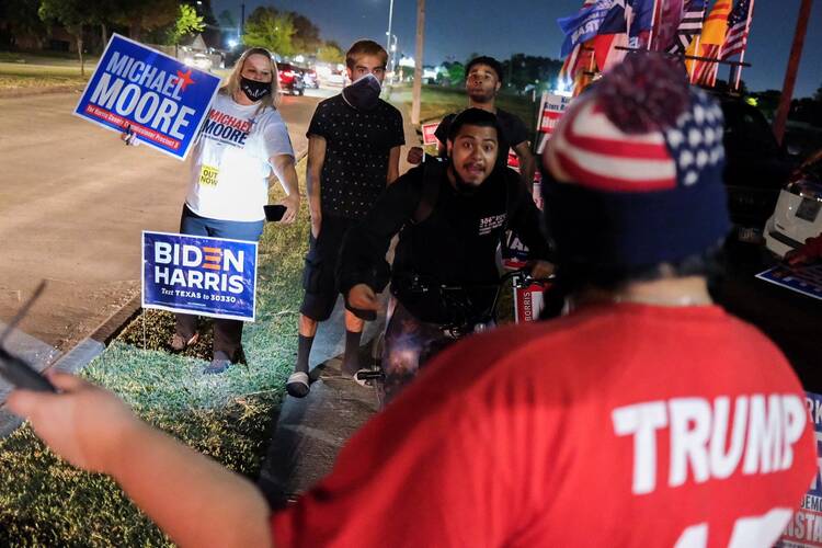Joe Biden supporters face off with a President Donald Trump supporter outside a polling site in Houston Nov. 3, 2020. (CNS photo/Go Nakamura, Reuters)