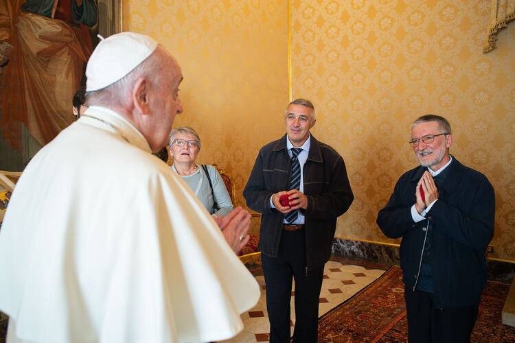 Pope Francis meets Father Maccalli, right, and members of his delegation at the Vatican on Nov. 9. (CNS photo/Vatican Media)