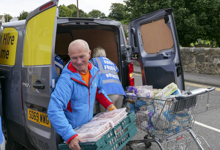 In August volunteers unload a van of food donations to a local food bank in the town of Penicuik, in Midlothian, Scotland. iStock