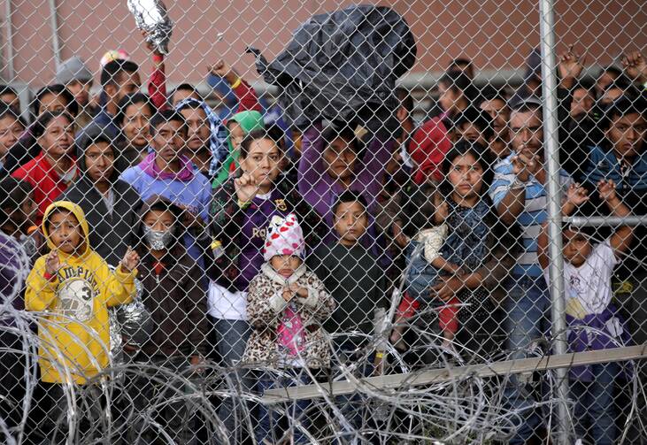 Central American migrants are seen inside an enclosure in El Paso, Texas