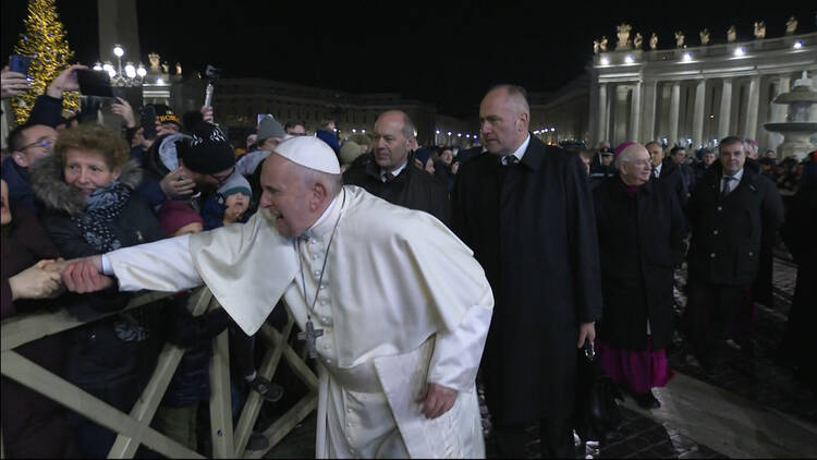 A woman pulls Pope Francis' hand as he greets people while walking to visit the Nativity scene in St. Peter's Square at the Vatican Dec. 31, 2019. At his Jan. 1 Angelus the pope apologized for the "bad example" he gave when he slapped this woman's hand. (CNS photo/Vatican Media)