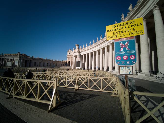 Several visitors enter an empty security queue before visiting St. Peter's Basilica at the Vatican on March 4. Visitors and pilgrims to churches, museums and landmarks in Rome have sharply declined following an outbreak of the COVID-19 coronavirus in northern Italy. (CNS photo/Junno Arocho Esteves)