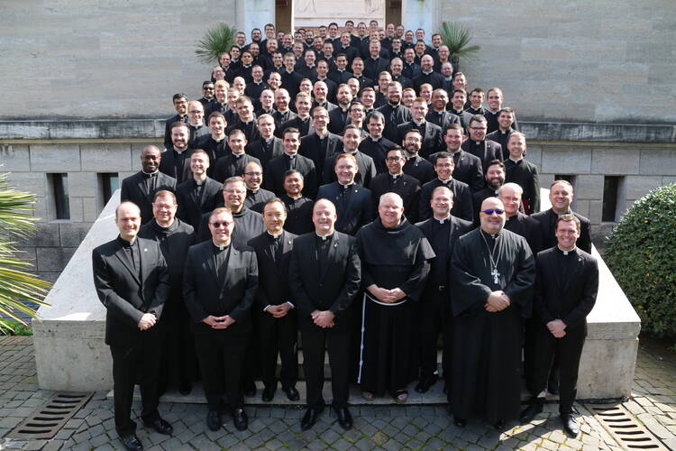 The staff and 92 seminarians at the Pontifical North American College in Rome pose for a photograph March 15, 2020, on the steps leading to the seminary chapel. A week later, the college informed the seminarians that they should return to the United States because of the ongoing COVID-19 pandemic. (CNS photo/courtesy of the Pontifical North American College)