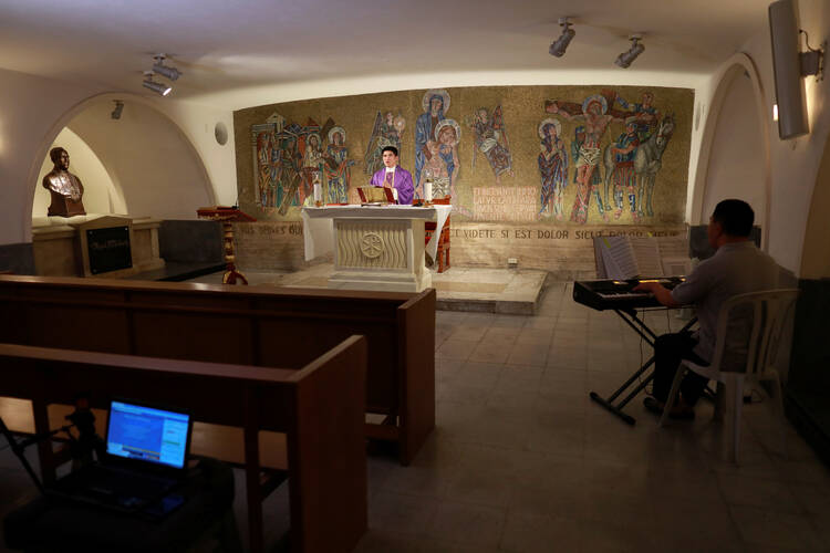 A priest celebrates Mass in a chapel of the cathedral in Manila, Philippines, March 15, 2020. The Mass was livestreamed on Facebook following the suspension of large gatherings due to the coronavirus pandemic. (CNS photo/Eloisa Lopez, Reuters)