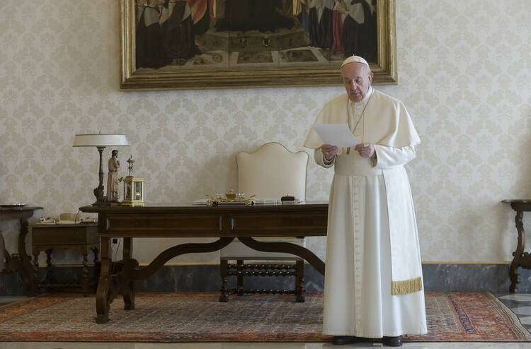 Pope Francis leads a global recitation of the Lord's Prayer from the library of the Apostolic Palace at the Vatican March 25, 2020. The pope and the Orthodox, Anglican and Protestant leaders who joined him for the prayer implored God's mercy on humanity amid the coronavirus pandemic. (CNS photo/Vatican Media)