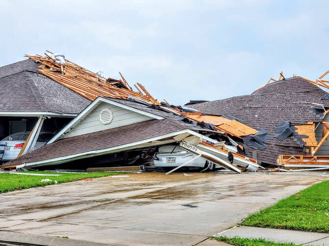 Damaged buildings and vehicles in Monroe, La., are seen in the aftermath of a tornado April 12, 2020. The National Weather Service reported April 13 that more than 30 tornadoes ripped across Texas, Louisiana, Mississippi and Georgia. (CNS photo/Peter Tuberville, social media via Reuters) 