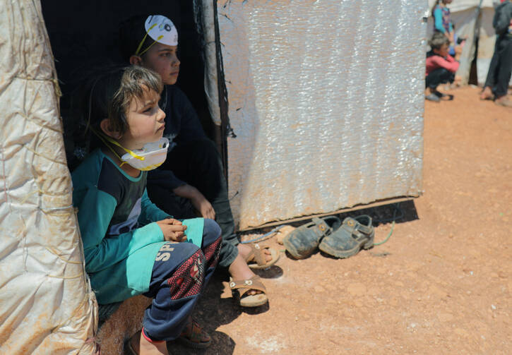 Displaced Syrian children are seen at a camp in Idlib on April 14, during the COVID-19 pandemic. Internally displaced people, those forced to flee their homes, but who do not cross into another country, still often need protection and special assistance, including from the church, said a new Vatican document released May 5. (CNS photo/Khalil Ashawi, Reuters)