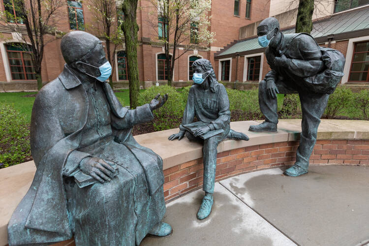The statues in St Vincent's Circle on DePaul University's Chicago campus are decorated with protective face masks April 30, 2020, during the COVID-19 pandemic. School officials say extreme caution tops the checklists for Catholic colleges throughout the U.S. to reopen in the fall. (DePaul University/Jeff Carrion) 