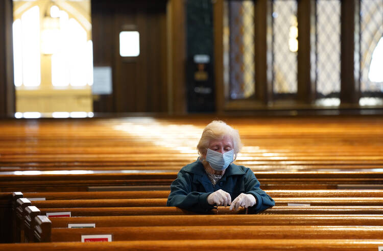 Alice Claus prays the rosary at St. Kevin Church in the Flushing section of the New York City borough of Queens on May 26, the first day the Diocese of Brooklyn, N.Y., permitted its churches to reopen amid the COVID-19 pandemic. (CNS photo/Gregory A. Shemitz) 
