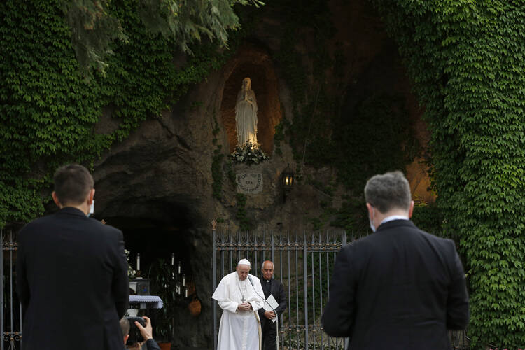 Pope Francis prays after leading the recitation of the rosary during a prayer service at the Lourdes grotto in the Vatican Gardens on May 30. (CNS photo/Paul Haring)