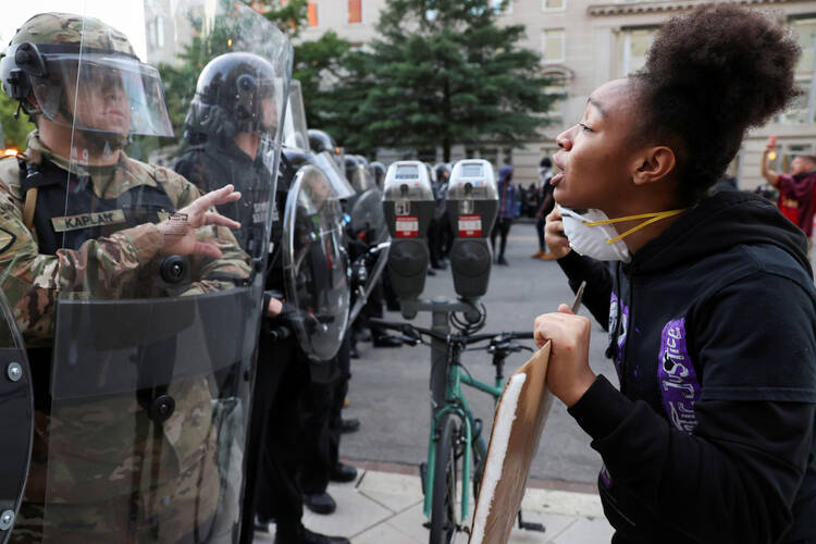 A woman confronts riot police during a Black Lives Matter protest in Washington on June 1. (CNS photo/Jonathan Ernst, Reuters)