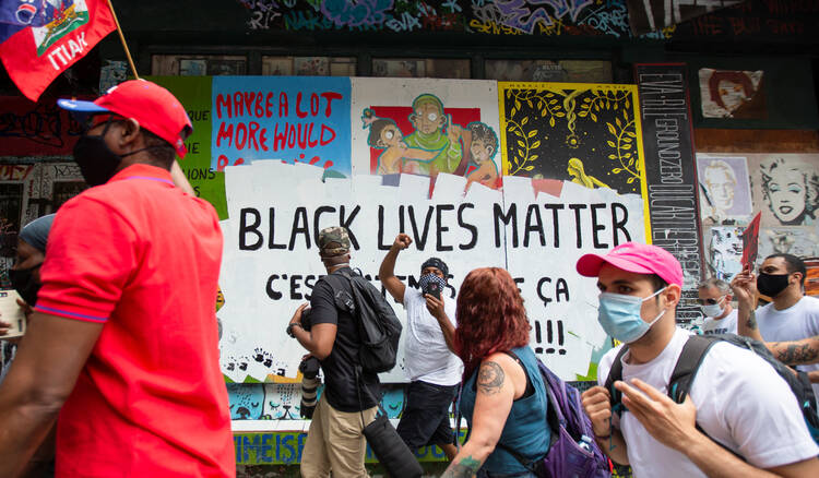 People march during a protest against racial inequality and police brutality in Montreal on June 7. (CNS photo/Christinne Muschi, Reuters)