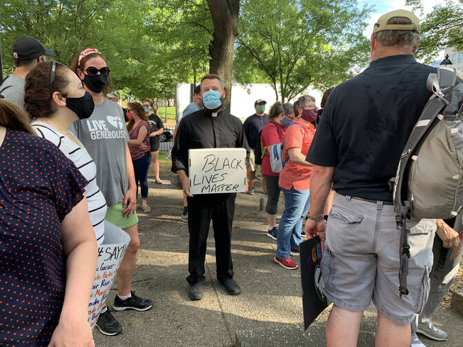 Father Joshua Laws, pastor of the Catholic Community of South Baltimore, participates in an interfaith prayer vigil against racism on June 3 in Baltimore. (CNS photo/Tim Swift, Catholic Review)