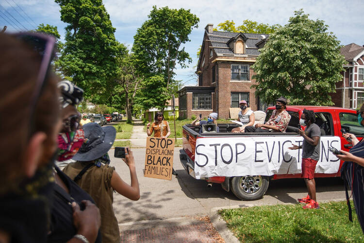 Tristan Taylor of Detroit speaks to people gathered June 9, 2020, during a caravan protest through Detroit neighborhoods while calling for relief for tenants and mortgage borrowers during the coronavirus pandemic. Catholic Charities' officials say people throughout the U.S. are at risk of eviction as the COVID-19 pandemic wreaks havoc on the economy. (CNS photo/Ryan Garza, USA Today Network via Reuters) 