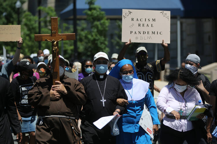 Washington Auxiliary Bishop Roy E. Campbell walks with others toward the National Museum of African American History and Culture in Washington, D.C., on June 8. (CNS photo/Bob Roller)