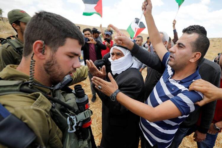 Palestinians argue with Israeli soldiers during a June 19, 2020, protest near Hebron, West Bank. (CNS photo/Mussa Qawasma, Reuters) 