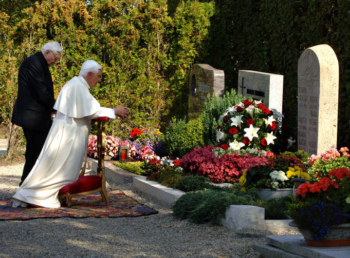 Msgr. Georg Ratzinger and his brother, now-retired Pope Benedict XVI, are seen in 2006 praying at their parents' grave in Pentling, Germany. Msgr. Ratzinger died July 1 at the age of 96. (CNS photo/Wolfgang Radtke, KNA) 