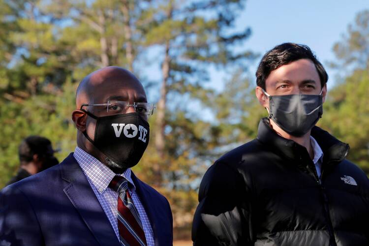 Democratic U.S. Senate candidates Rev. Raphael Warnock and Jon Ossoff appear together at a campaign rally in Augusta, Ga., Jan. 4, 2021.