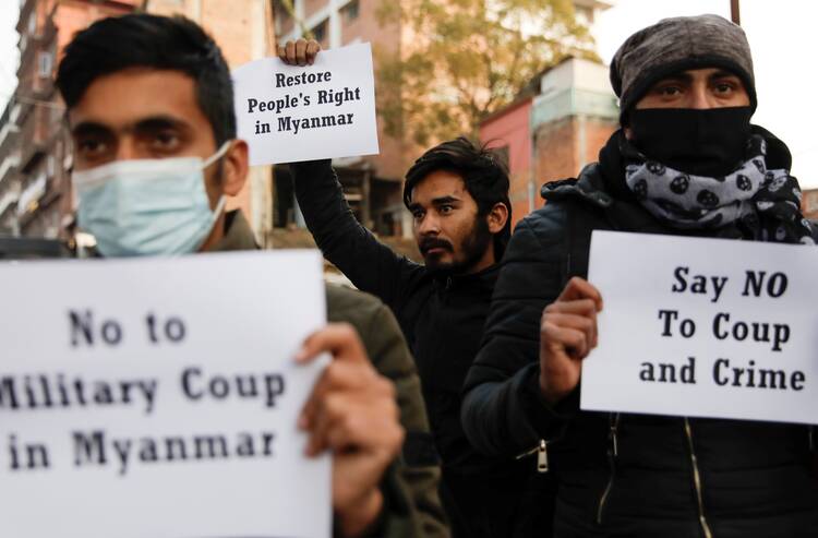 Activists hold placards during a protest in Kathmandu, Nepal, Feb. 1, 2021, after Myanmar's military seized power from a democratically elected civilian government and arrested its leaders. (CNS photo/Navesh Chitrakar, Reuters)