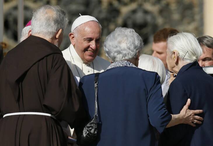 Pope Francis greets people during an encounter with the elderly in St. Peter's Square at the Vatican in this Sept. 28, 2014, file photo. During his Jan. 31 Sunday Angelus, the pope announced the establishment of a World Day of Grandparents and the Elderly. (CNS photo/Paul Haring)