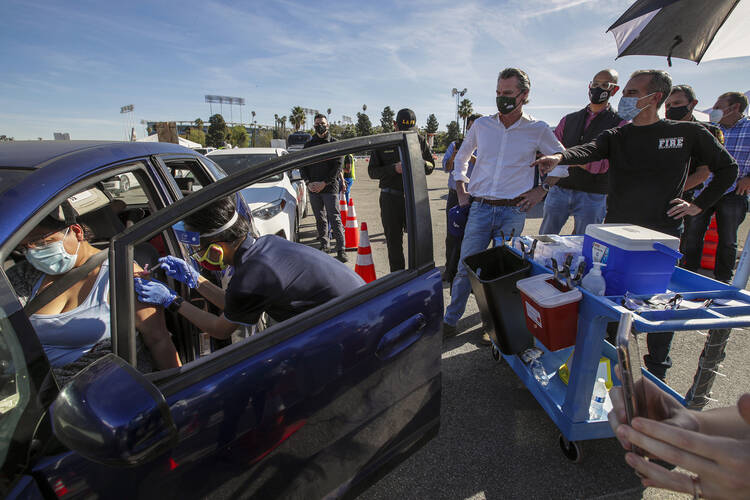 Los Angeles Mayor Eric Garcetti, right, and Gov. Gavin Newsom tour the mass Covid-19 vaccination site at Dodger Stadium in Los Angeles on Jan. 15. (Irfan Khan/Los Angeles Times via AP, Pool, File)