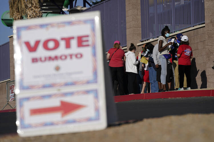 People wait in line at a polling place on Nov. 3, 2020, in Las Vegas. (AP Photo/John Locher, File)