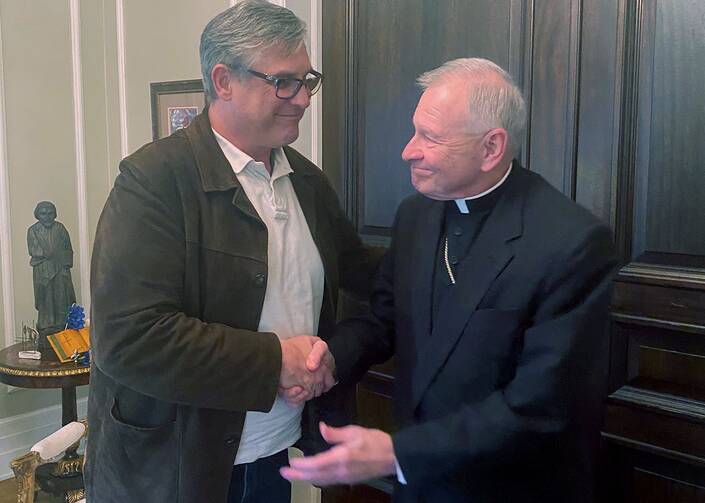 Kevin Bourgeois with Archbishop Gregory Aymond (CNS photo/courtesy Archdiocese of New Orleans)