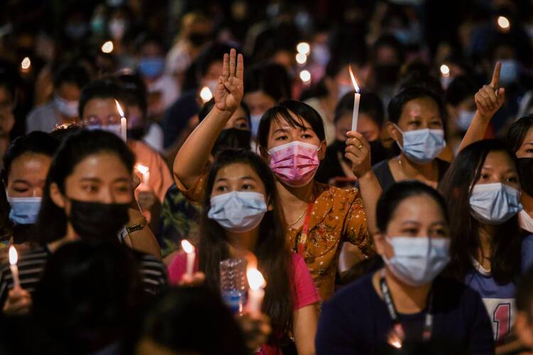 People hold candles as they take part in an anti-coup protest in Yangon, Myanmar, March 14, 2021. (CNS photo/Reuters)