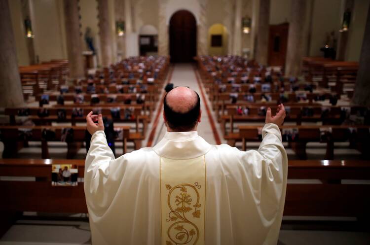 Father Giancarlo Ruggieri celebrates a livestreamed Easter Mass in San Giorgio Ionico, Italy, on April 12, 2020. (CNS photo/Alessandro Garofalo, Reuters)