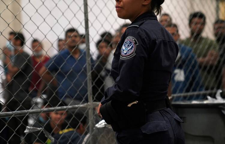 A Customs and Border Protection agent monitors detainees at a Border Patrol station in McAllen, Texas, on July 12, 2019. (CNS photo/Veronica G. Cardenas, Reuters)