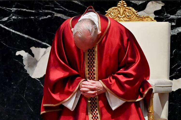 Pope Francis prays as he leads the Good Friday Liturgy of the Lord's Passion April 2, at the Altar of the Chair in St. Peter's Basilica at the Vatican. (CNS photo/Andreas Solaro, pool via Reuters)